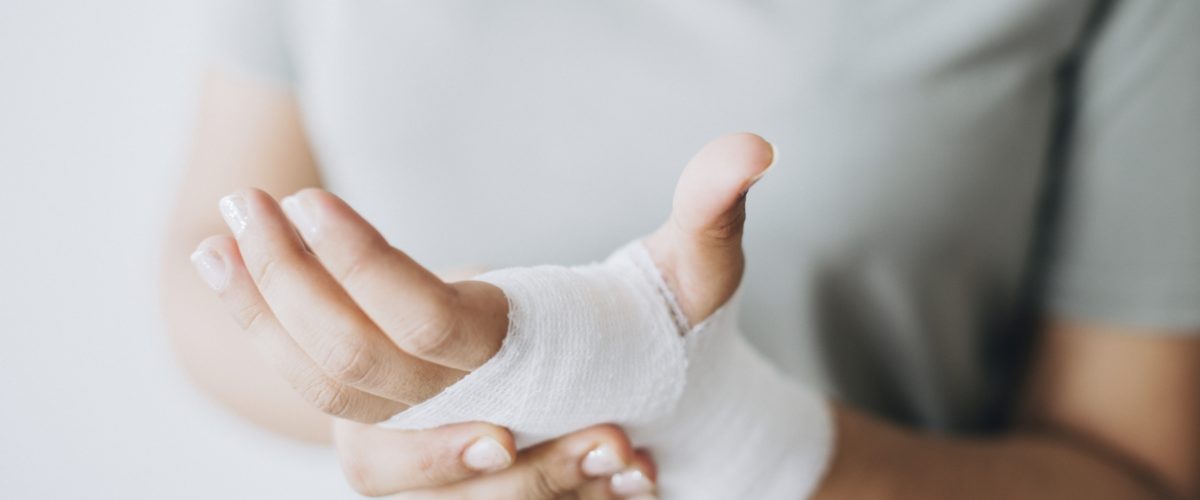 Woman with gauze bandage wrapped around her hand